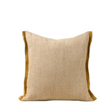 Beige pillow with brown trim 