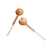 Two wooden spoons with white handles 